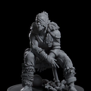 May include: A grey, detailed figurine of a warrior sitting with a weapon in hand. The warrior is wearing a blindfold and has a chain around their leg.