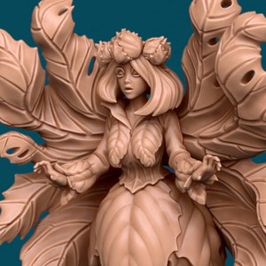 May include: A detailed figurine of a fairy with large, leafy wings. The fairy is wearing a dress and crown made of leaves and has a delicate, feminine face.