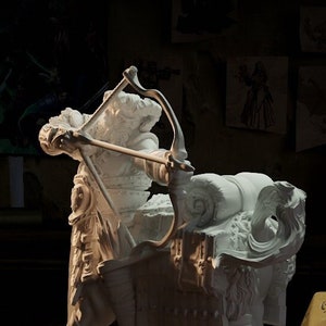 May include: White painted miniature figurine of a centaur archer holding a bow and arrow, riding a horned beast. The figurine is on a round base and next to a yellow 20-sided die.