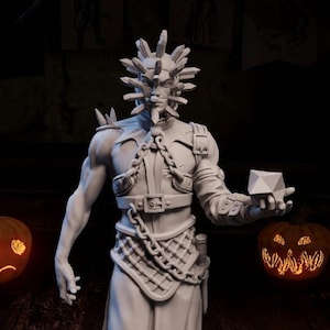 May include: A white 3D printed figurine of a skeletal figure wearing a long robe and a spiked helmet. The figure is holding a small cube in its right hand. The figurine is on a black circular base.