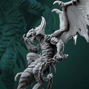 May include: A grey, detailed miniature of a winged, reptilian creature with sharp claws and teeth. The creature is perched on a rocky base with a textured surface. The miniature is a tabletop game piece.