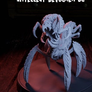May include: Two grey, detailed, 3D printed, spider-like creatures with sharp claws and fangs. The larger creature is labelled "Intellect Devourer 02" and the smaller creature is labelled "Intellect Devourer 01".