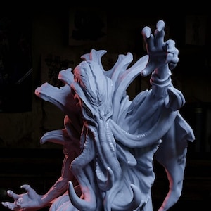 May include: A white painted miniature figurine of a tentacled creature with a humanoid form. The creature has a long, flowing robe and is posed with one arm raised. The figurine is on a black base and is next to a yellow 20-sided die.