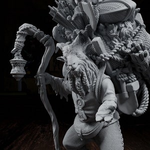 May include: A grey, detailed figurine of a goat-like creature carrying a large pack on its back. The creature is holding a staff with a lantern on the end. The figurine is standing on a circular base.