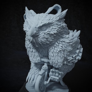 May include: A white owl figurine riding a small bicycle. The owl has detailed feathers and large, round eyes. The bicycle has a single front wheel and a basket on the handlebars.