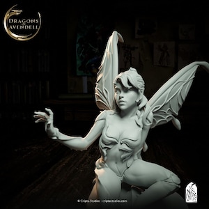 May include: A white, detailed, sculpted figurine of a fairy with wings outstretched. The fairy has long hair and is wearing a leafy, sculpted bodice. The figurine is posed in a sitting position with one hand raised.