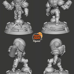 May include: A 3D printed model of a video game character, Samus Aran from Metroid, in a chibi style. The model is posed in a dynamic action pose, holding a weapon. The model is printed in gray plastic and is set on a base with a textured surface.
