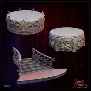 May include: Three gray miniature display bases for tabletop gaming. One circular base features a diamond-patterned top with ornate leaf and mask carvings. Another circular base has a draped curtain design with theater masks. A staircase base features railings.