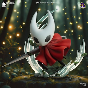 May include: A detailed figurine of a character with a white head, large black eyes, and a red cape. The figure is holding a silver sword and is surrounded by a clear, curved structure with green accents. The background features a forest setting with bokeh lights.