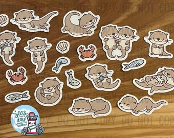 May include: A set of 13 adorable otter stickers featuring various poses, including otters holding hands, swimming, and cuddling. The stickers are perfect for adding a touch of whimsy to journals, laptops, water bottles, and more.