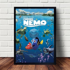 May include: A movie poster for the Disney Pixar film Finding Nemo. The poster features a blue and yellow fish, a shark, and a turtle in a blue ocean setting. The title "Finding Nemo" is written in white letters with a black outline.