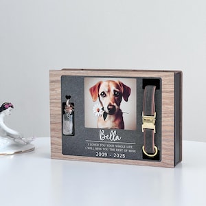 May include: A wooden box with a photo of a dog, a small glass jar, and a brown leather dog collar. The box has a personalized inscription that reads "Bella I loved you your whole life. I will miss you the rest of mine 2009 - 2025".