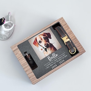 May include: A wooden box with a photo of a dog, a small glass vial, and a brown leather dog collar with a gold buckle. The box has a black background with the text "Bella I LOVED YOU YOUR WHOLE LIFE. I WILL MISS YOU THE REST OF MINE 2009 - 2025"