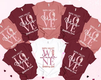May include: Six maroon, pink, and white t-shirts with the text "NAPA VALLEY LOVE WINE" and "Birthday Crew" or "Birthday Girl" printed on them.