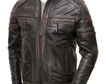 May include: A distressed black leather jacket with a stand-up collar, zipper closure, and multiple pockets. The jacket features quilted shoulder and arm details, giving it a vintage, worn look. The jacket is displayed on a mannequin.