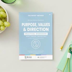 May include: A light blue workbook titled The 8wise Method: Purpose, Values & Direction. The cover features white text, a yin-yang symbol, and a colorful logo at the bottom. It is positioned next to a wooden pencil, a green notebook with keys, and a bowl of green grapes.