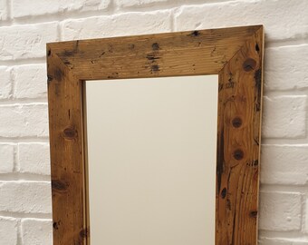 Mirror in a wooden frame made from reclaimed Victorian floorboards.