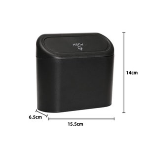 May include: A black rectangular trash bin with a curved lid. The lid has the word "PUSH" and a hand icon. The bin measures 6.5cm wide, 15.5cm long, and 14cm high.