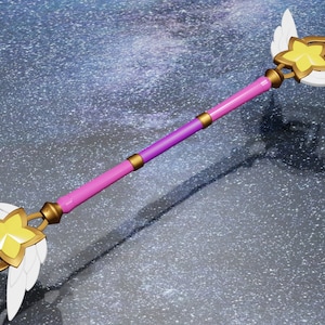 May include: A pink and purple wand with gold accents and white wings. The wand has a yellow star at each end.