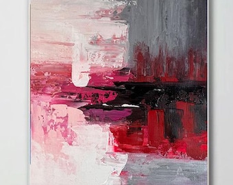 May include: Abstract painting with pink, red, and gray brushstrokes. The painting is on a white canvas and is framed in a thin black frame.