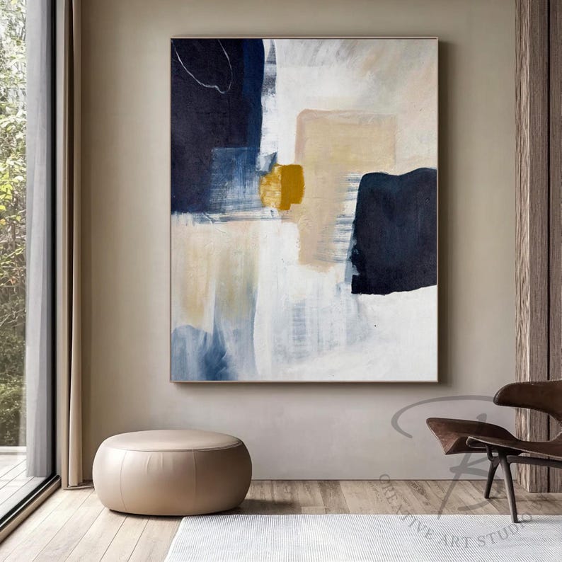 a painting hanging on a wall next to a chair