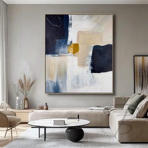 a living room filled with furniture and a painting on the wall