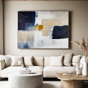 a living room with a large painting on the wall