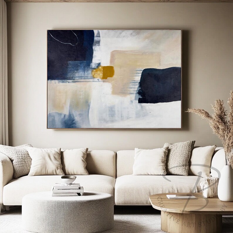 a living room with a large painting on the wall