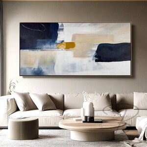 a living room with a large painting on the wall