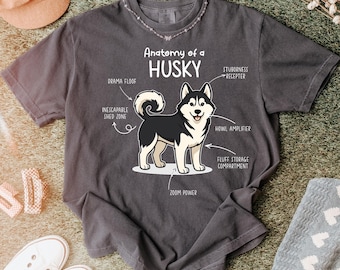 May include: Dark gray t-shirt featuring a cartoon illustration of a Husky dog with the text "Anatomy of a Husky." The design includes labeled parts like "Drama Floof" and "Zoom Power."