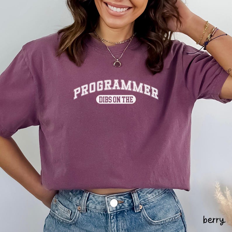 May include: A purple t-shirt with the text "PROGRAMMER DIBS ON THE" in white.