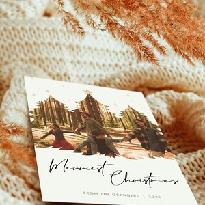 May include: A white Christmas card with a photo of a family of four walking through a forest. The photo is framed by a silhouette of three Christmas trees. The text "Merriest Christmas" is written in black cursive script. The text "From the Grangers | 20XX" is written in black below the photo.
