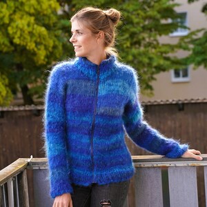 May include: A blue and purple striped fuzzy cardigan with a zip closure.