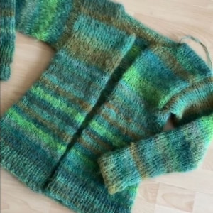 May include: A green, brown and yellow striped knitted cardigan with long sleeves.