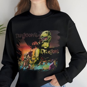 May include: Black sweatshirt with a graphic print of a green dragon and characters from the Dungeons and Dragons game. The print has a colorful, abstract background.