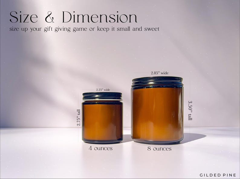 two jars of honey sitting on a table next to each other
