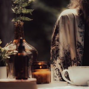 a woman sitting at a table with a coffee cup