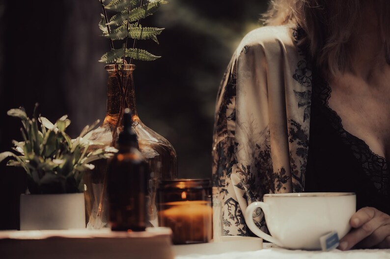 a woman sitting at a table with a coffee cup