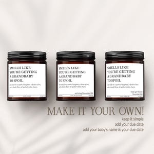 Three brown jars with black lids, each containing a different scent, are arranged in a row. The jars have white labels with black text that reads "Smells like you're getting a grandbaby to spoil". Below the jars, there is text that says "MAKE IT YOUR OWN! keep it simple add your baby's name & your due date".
