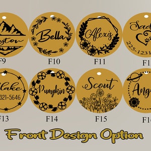 May include: A collection of gold-colored pet tags with various designs and names. Designs include mountains, floral wreaths, and celestial elements. Some tags feature names like "Peyton," "Bella," and "Alexis," along with phone numbers.