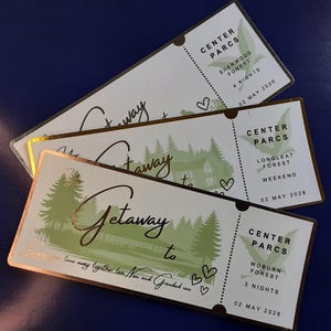May include: Three Center Parcs getaway tickets with gold foil detailing. Each ticket displays a forest scene, the words "Getaway to," and the destination: Sherwood Forest, Longleat Forest, and Woburn Forest. The tickets are dated 02 May 2026.