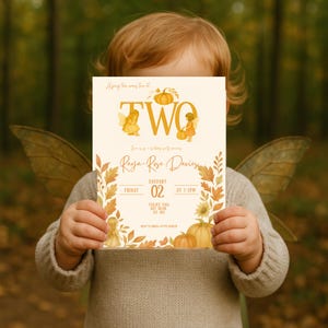 May include: A child holding a cream-coloured birthday party invitation. The invitation features the word "TWO" in gold, with fairy illustrations and pumpkin accents. The text includes the name "Raya-Rose Davies" and event details.