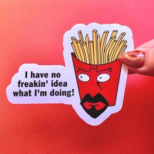 May include: A die-cut sticker featuring a cartoon image of a red french fry container with a face and the text "I have no freakin' idea what I'm doing!" The sticker is held against a red background.
