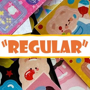 May include: A collection of colorful stickers with various designs, including bears, desserts, and other cute illustrations. The word "REGULAR" is displayed in orange text on a white background. The stickers are in shades of pink, blue, yellow, and other bright colors.