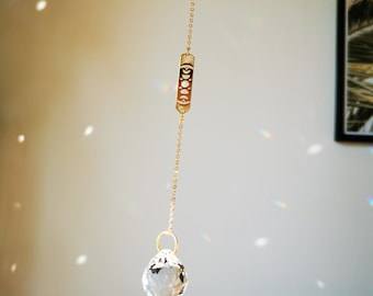 The Suncatcher Mini Moon Phase Filigree - Small suncatcher with moon and rainbow crystal to hang on the window with rainbow effect