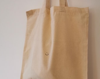 The Suncatcher - Bolsa de yute con cara sonriente, asas largas estampadas con un dicho, bolsa de algodón hecha a mano, bolsa de mano, bolsa de compras, bolso de hombro