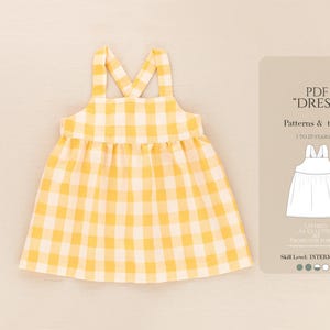 May include: A yellow and white gingham sundress with crisscross straps. The dress has a gathered skirt and is designed for children aged 1 to 10 years old. A card on the right side reads "PDF Dress" with pattern and tutorial information.