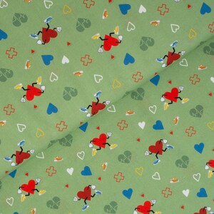 May include: Green fabric with a repeating pattern of red hearts with legs and arms, blue hearts, white hearts, yellow hearts, red crosses, and green leaves.