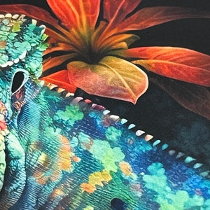 May include: A close-up of a chameleon's skin, showing its intricate patterns of blue, green, and yellow. A large red flower with green leaves is partially visible in the background.