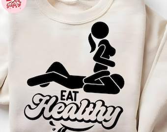 May include: Cream-colored sweatshirt with a black graphic of two stick figures in a sexual position, with the words "EAT Healthy" in a stylized font. The sweatshirt has a crew neck and long sleeves.